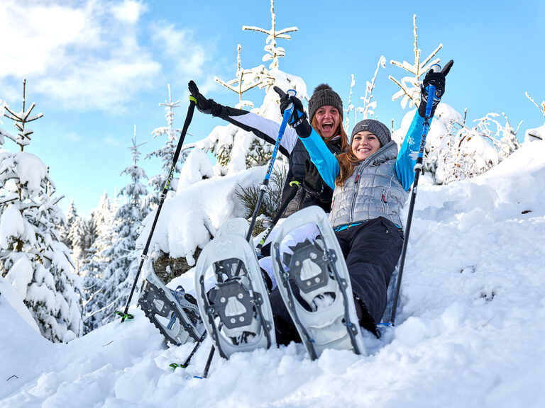 Zwei Schneeschuwanderer haben Spass und Gute Laune im Schnee im Bayerwald.